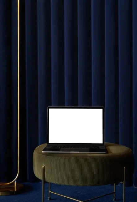 A miniature shopping cart placed on a laptop keyboard symbolizing online shopping and e-commerce.